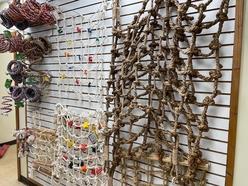 Variety of climbing ropes and nets displayed on a wall. Features different materials and textures, highlighting options for outdoor activities and sports.